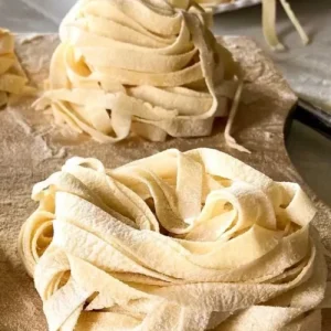 egg fettuccini wrapped in litte nests on cutting board